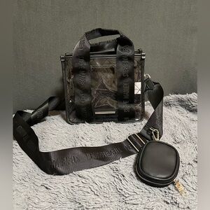 Steve Madden clear crossbody bag with a black logo strap and a small pouch
